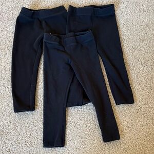 Three pairs of primary black leggings — one fleece
